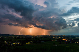 50227901 - high angle view of storm and lightning over villages