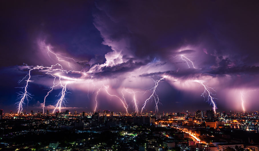 40609402 Lightning Storm Over City In Purple Light